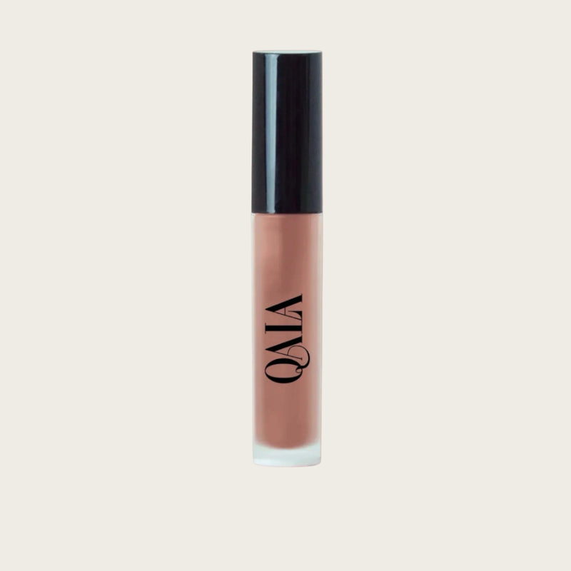 Close-up of QALA Lush Glow Liquid Lip Gloss in sleek recyclable packaging, showing radiant sheen and doe-foot applicator for precise, high-shine vegan lip color.
