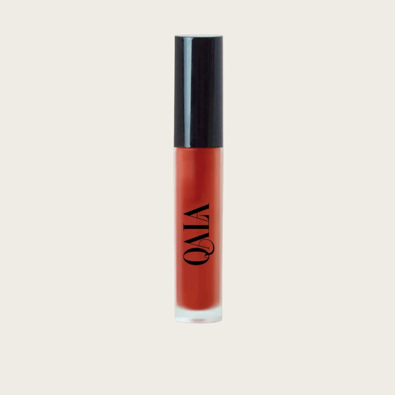 Close-up of QALA Lush Glow Liquid Lip Gloss in sleek recyclable packaging, showing radiant sheen and doe-foot applicator for precise, high-shine vegan lip colour.
